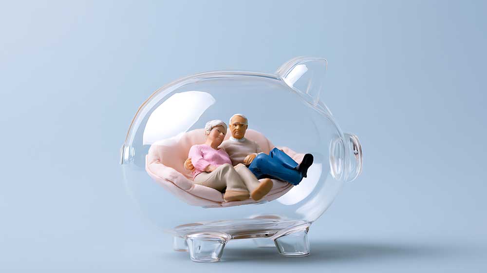 Retried couple enjoying their savings in a peverbial piggy bankj