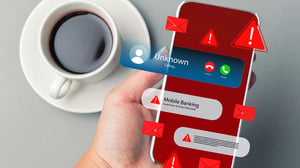 phone screen alerts consumer to a suspicious bank account withdrawal and unknown caller.