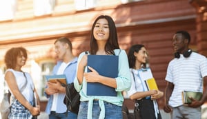 Young student happy to be enrolled and on campus after receiving student loans
