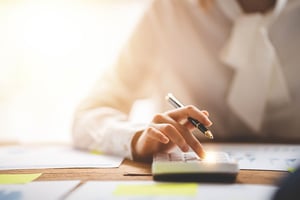 Person working on rebuilding credit finances with a calculator