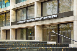 A photo of the front of a government building with a sign over the entrance reading Consumer Financial Protection Bureau.